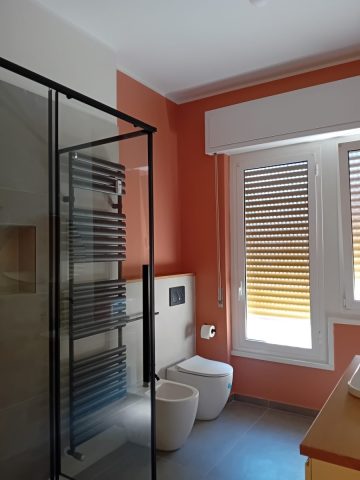 Foto 16 - Il nuovo bagno visto dalla porta di ingresso verso la finestra. Un bel color tra il mattone chiaro e il rosa antico scuro mette in evidenza sia il contorno delle finestre sia il muretto basso con i sanitari